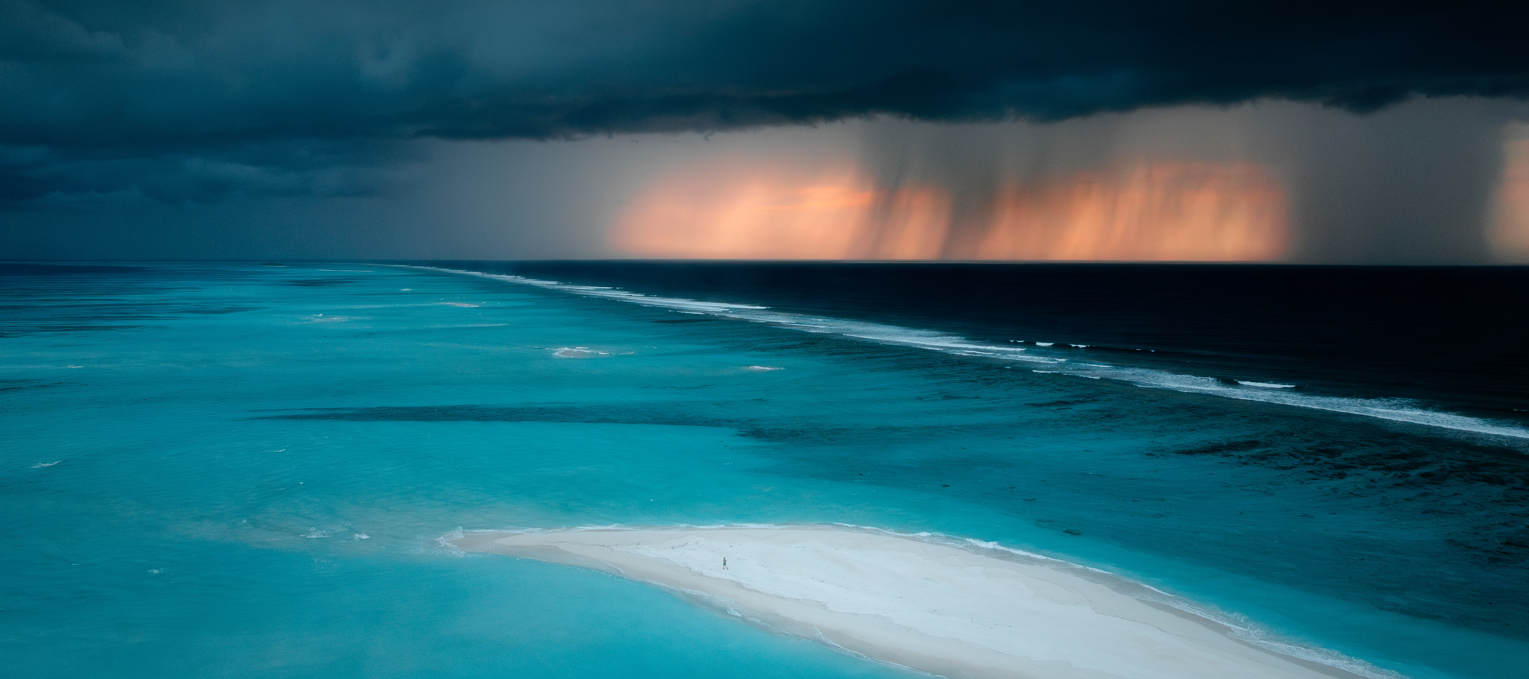 Ocean waves in a rain storm at sunset